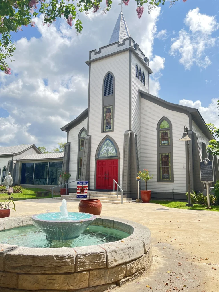 Front View of St. Mary and Joseph Catholic Church near Plantersville, TX with fountain in the foreground.